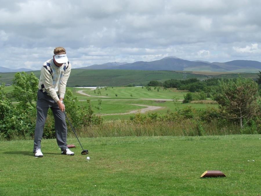 Golfer teeing off at Whitehaven Golf Club